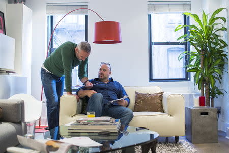 LGBT activist Daniel Maury relaxes at home with his partner, Mark Paulson, in New York April 13, 2015. REUTERS/Lucas Jackson