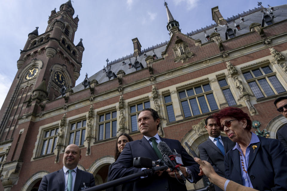 Mexico's legal advisor Alejandro Celorio Alcantar, center, and agent and ambassador Carmen Moreno Toscano, right, gave a brief statement outside the International Court of Justice in The Hague, Netherlands, Tuesday, April 30, 2024, where Mexico took Ecuador to the United Nations' top court accusing the nation of violating international law by storming into the Mexican embassy in Quito and arresting former Ecuador Vice President Jorge Glas, who had been holed up there seeking asylum in Mexico. (AP Photo/Peter Dejong)