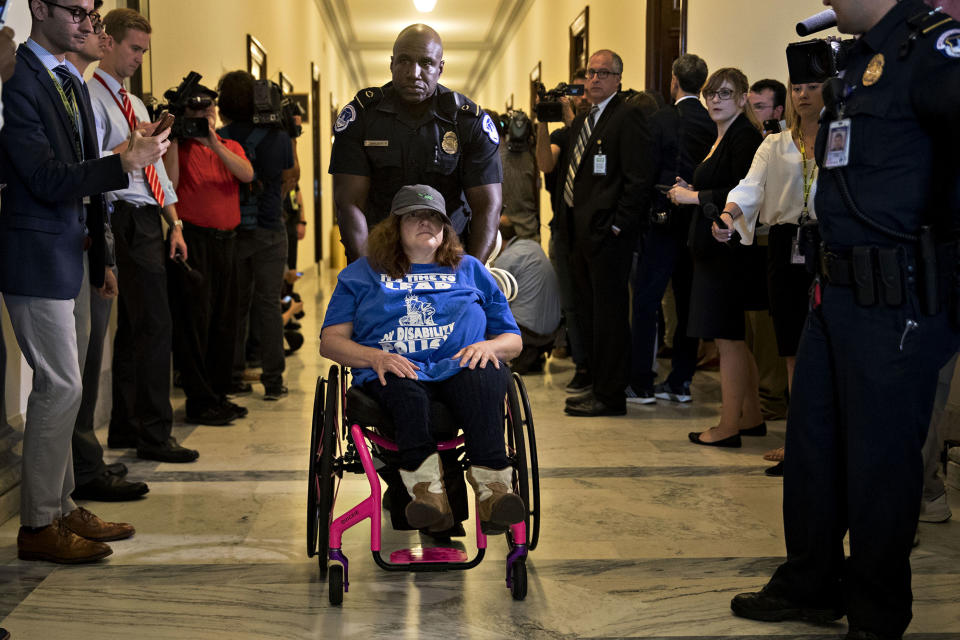 A protester is led away