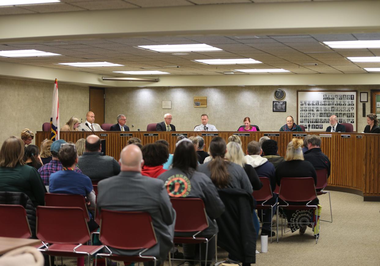 School board members of the Lafayette School Corporation prepare to begin February's meeting in an almost full room, on Feb. 13, 2023, in Lafayette, Ind.