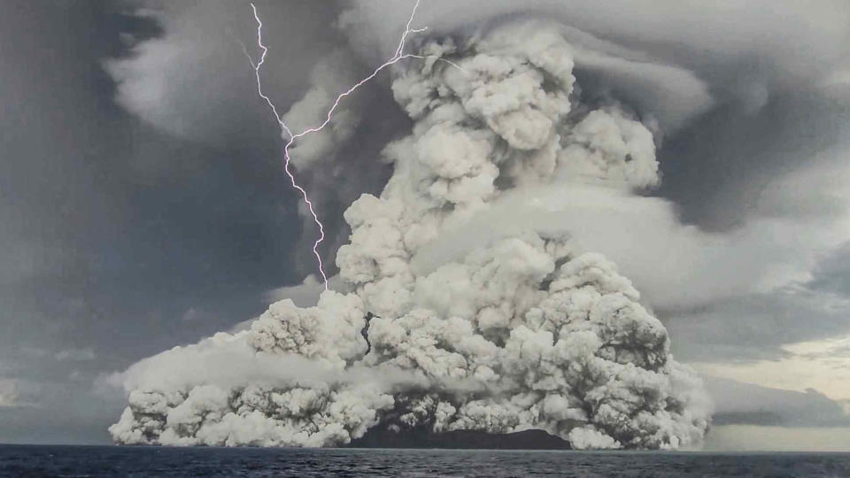 The underwater Hunga Tonga-Hunga Ha'apai volcano eruption releases plume of steam amid a lightning strike