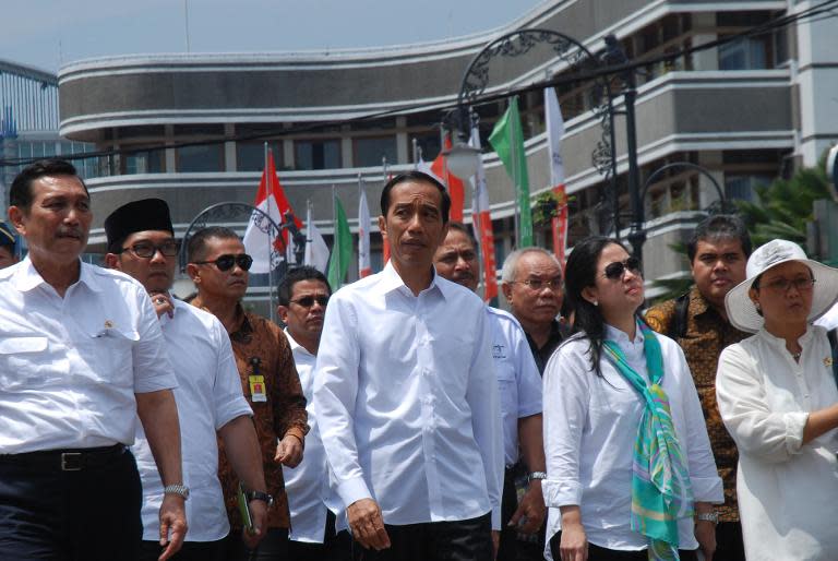 Indonesian President Joko Widodo (C), accompanied top officials, inspect preparations for the Asia-Africa Conference in Bandung in West Java province, on April 16, 2015