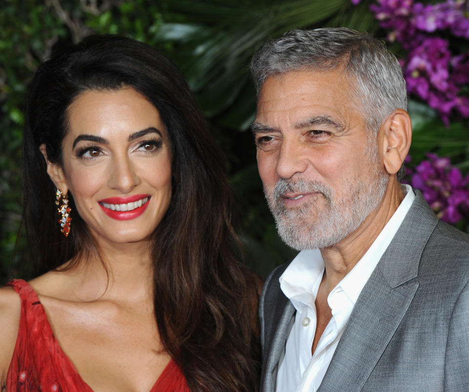 A close up shot of Amal and George Clooney attending a red carpet event