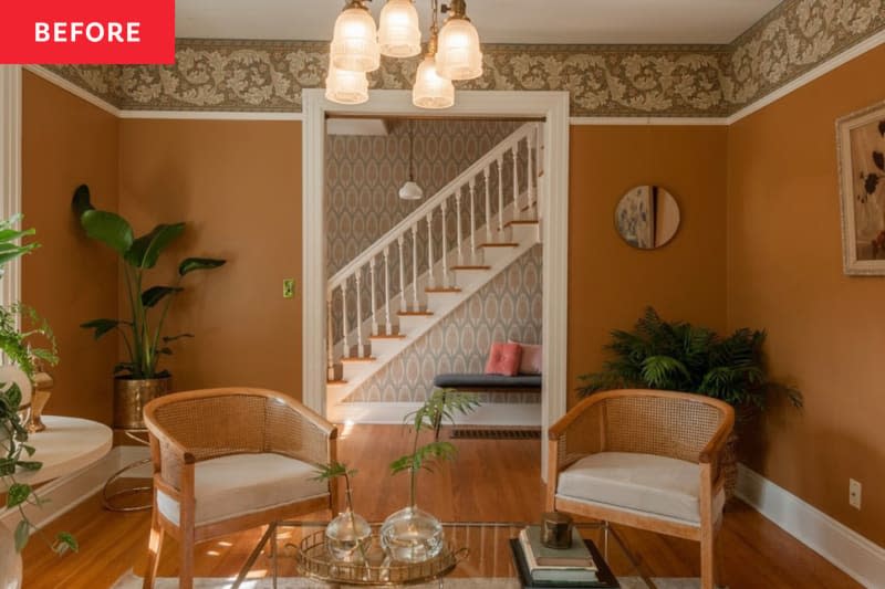 Rust colored living room with caned armchairs.