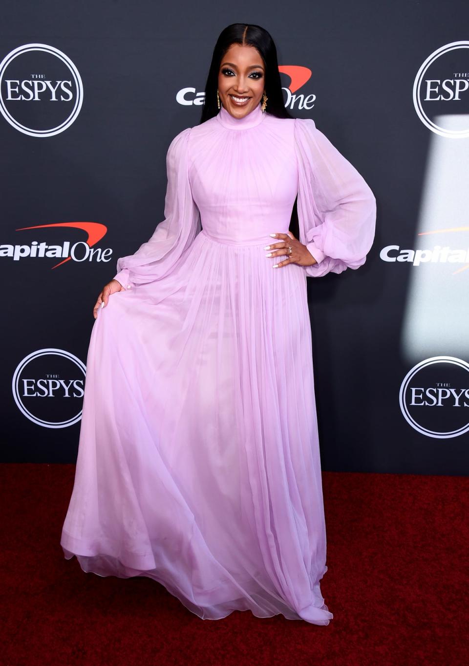 US singer Mickey Guyton wore a high necked, flowing pink dress with puffed sleeves (Jordan Strauss/AP) (AP)