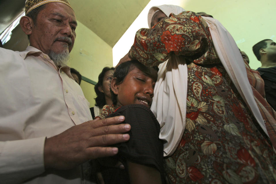 In this June 4, 2013 photo, young ethnic Rohingya asylum seeker Senwara Begum, center, cries during the trial of her brother, Mohamad Husein, who was accused of taking part in a brawl that left eight Buddhist Burmese fishermen dead, at a district court in Medan, North Sumatra, Indonesia. Senwara had slept through the brawl in a separate quarter for women. But when she awoke the next morning, her brother was gone. (AP Photo/Binsar Bakkara)