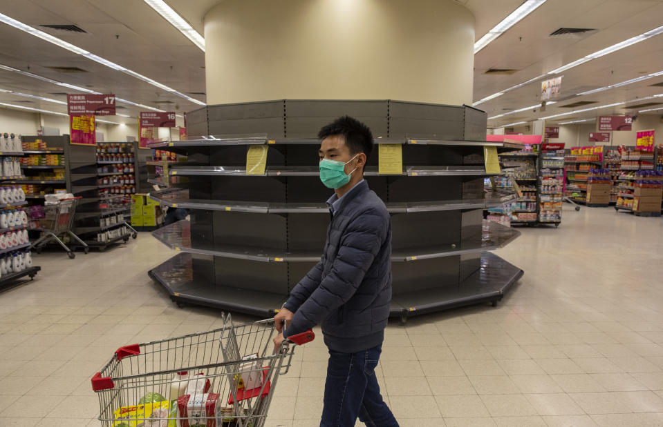  A man shopper wearing a face mask walks past empty supermarket shelves, usually stocked with toilet paper and kitchen rolls. The death toll from the covid-19 coronavirus epidemic past 1, 100 and infected over 45, 000 people worldwide on february 12. A shopper wearing a face mask walks past empty supermarket shelves, usually stocked with toilet paper and kitchen rolls. The death toll from the covid-19 coronavirus epidemic past 1, 100 and infected over 45, 000 people worldwide on february 12. (Photo by Miguel Candela / SOPA Images/Sipa USA) 