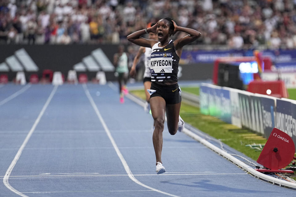 FILE - Faith Kipyegon, of Kenya, crosses the finish line to win the Women 5000 meters setting a new world record during the Meeting de Paris Diamond League athletics meet in Paris, Friday, June 9, 2023. "We're trying to clean up our country," said Faith Kipyegon, the Kenyan middle-distance runner who broke three world records this year, has never failed a doping test, but was asked at a recent press conference - like many of her compatriots often are - to account for the more than 180 doping sanctions handed out to Kenyans since 2017. (AP Photo/Michel Euler, File)