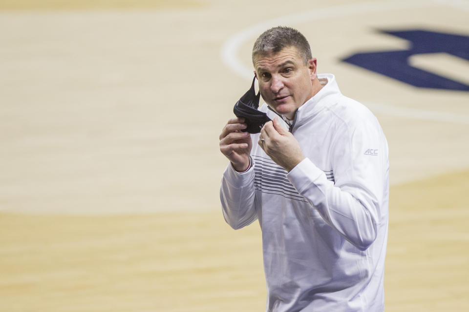 FILE - Boston College head coach Jim Christian calls to his bench as he fixes his face mask during an NCAA college basketball game against Notre Dame in South Bend, Ind., in this Saturday, Jan. 16, 2021, file photo. Notre Dame won 80-70. Boston College fired basketball coach Jim Christian on Monday, Feb. 15, 2021, with three weeks left in his seventh season. Assistant Scott Spinelli will serve as interim head coach for the rest of the season. (AP Photo/Robert Franklin, File)