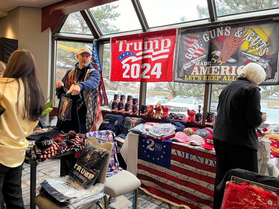 Jason Jisa, owner of the Trump Store, points out merchandise to customers at the Kansas GOP Convention in Overland Park. Katie Bernard/The Kansas City Star