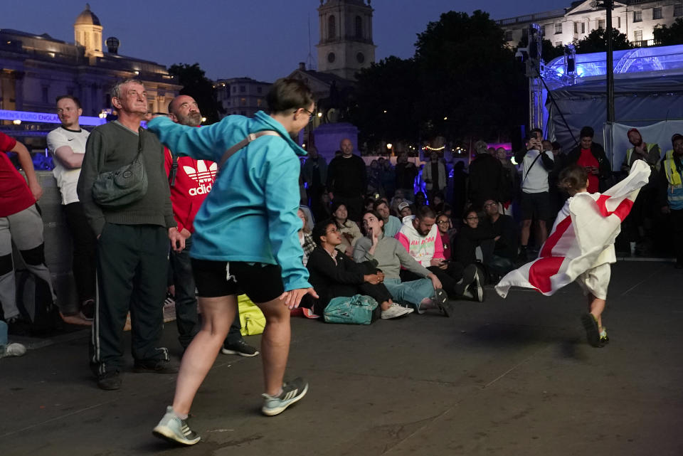 England supporters react as they watch a live screening of the Women's Euro 2022 semifinal soccer match between England and Sweden at the fan area in Trafalgar Square in London, England, Tuesday, July 26, 2022. (AP Photo/Albert Pezzali)