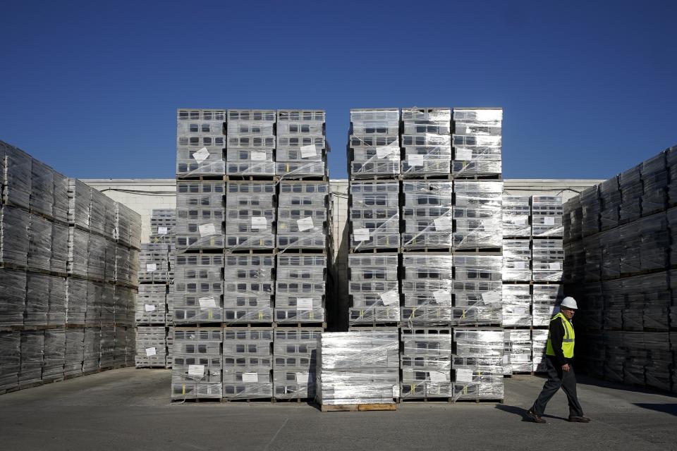 Jeff Hansen, vice president of Architectural Sales & Marketing, walks past stored concrete blocks that were made with liquid carbon dioxide as an ingredient, at the Glenwood Mason Supply Company, Tuesday, April 18, 2023, in the Brooklyn borough of New York. New York is forcing buildings to clean up, and several are experimenting with capturing carbon dioxide, cooling it into a liquid and mixing it into concrete where it turns into a mineral. (AP Photo/John Minchillo)