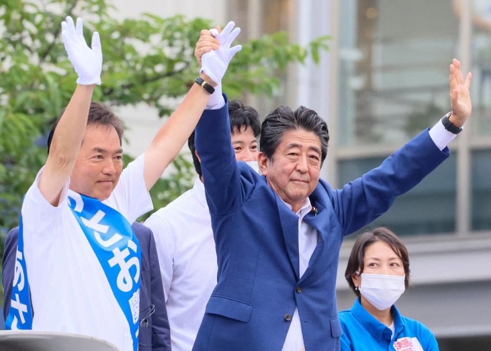 Former Japanese prime minister Shinzo Abe cheering at an event on Wednesday with Liberal Democratic Party candidate Keiichiro Asao (AFP/Getty)