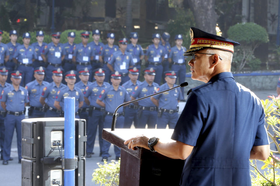 In this photo provided by Philippine National Police Public Information Office, Philippine National Police chief Gen. Oscar Albayalde addresses hundreds of police officers during the flag-raising ceremony at Camp Crame Monday, Oct. 14, 2019 in suburban Quezon city, northeast of Manila, Philippines. Albayalde resigned on Monday after he faced allegations in a Senate hearing that he intervened as a provincial police chief in 2013 to prevent his officers from being prosecuted for allegedly selling a huge quantity of illegal drugs they had seized. (Philippine National Police via AP)