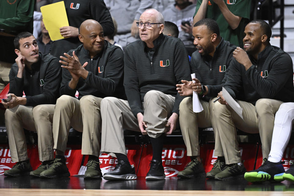 Miami head coach Jim Larrañaga, center, watches play in the second half of an NCAA college basketball game against Providence with Director of Basketball Operations Jeff Dyer, left, Associate Head Coach Bill Courtney, second from left, and assistant coaches Kotie Kimble, second from right, and DJ Irving, right, Saturday, Nov. 19, 2022, in Uncasville, Conn. (AP Photo/Jessica Hill)