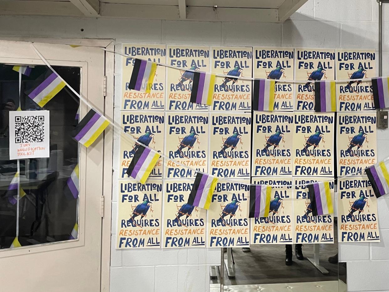 A wall lined with non-binary flags and posters is seen at the Wright House of Fashion on Thursday, March 14, 2024 in Iowa City, Iowa. The Wright House hosted a press conference for seven members of the queer community in the wake of the acquittal of Tara Dutcher.