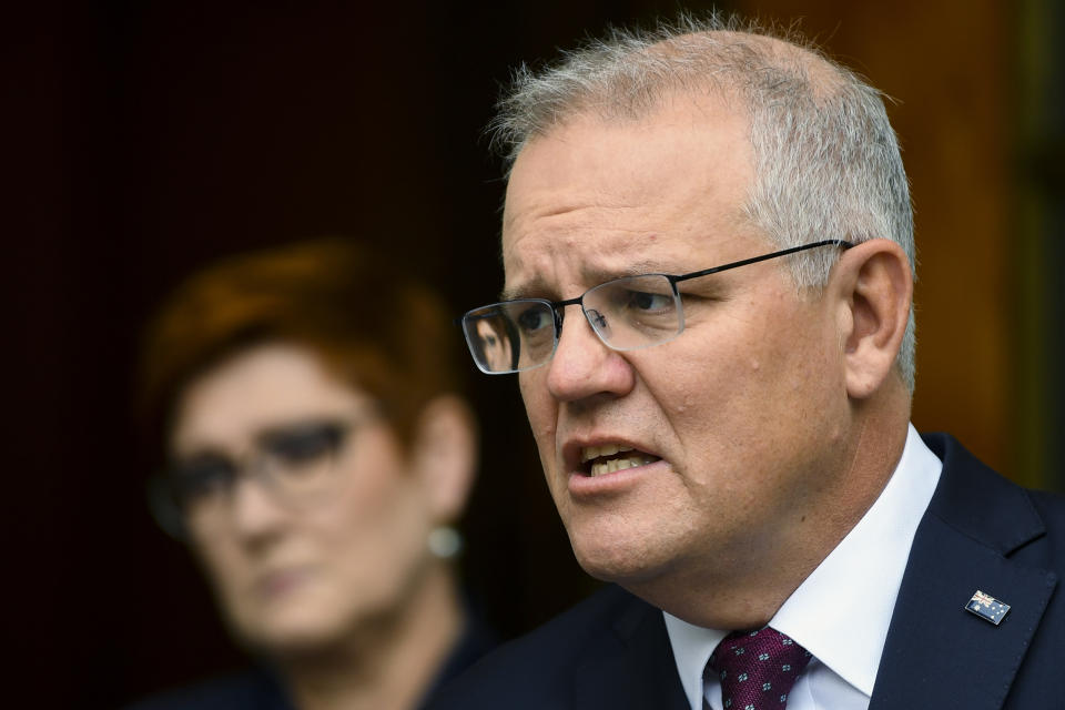 Australian Prime Minister Scott Morrison speaks to the media during a press conference at Parliament House in Canberra, Wednesday, March 17, 2021. Morrison said Australian government is ramping up its COVID-19 vaccination support for Papua New Guinea in a bid to contain a concerning wave of infections in a near-neighbor. (Lukas Coch/AAP Image via AP)