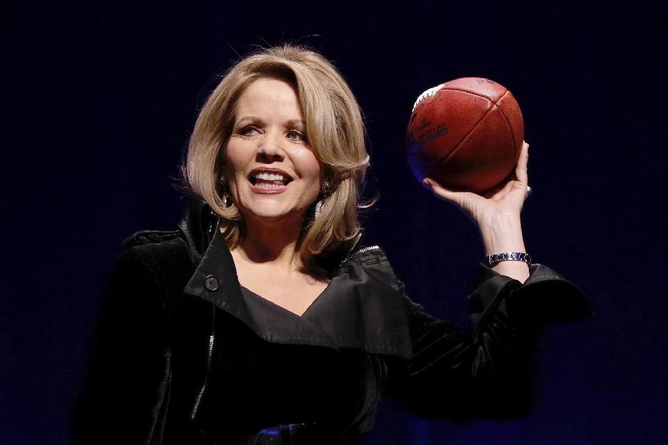 Opera singer Renee Fleming who will sing the National Anthem before the NFL Super Bowl XLVIII football game holds the game ball during a press conference Thursday, Jan. 30, 2014, in New York. (AP Photo)