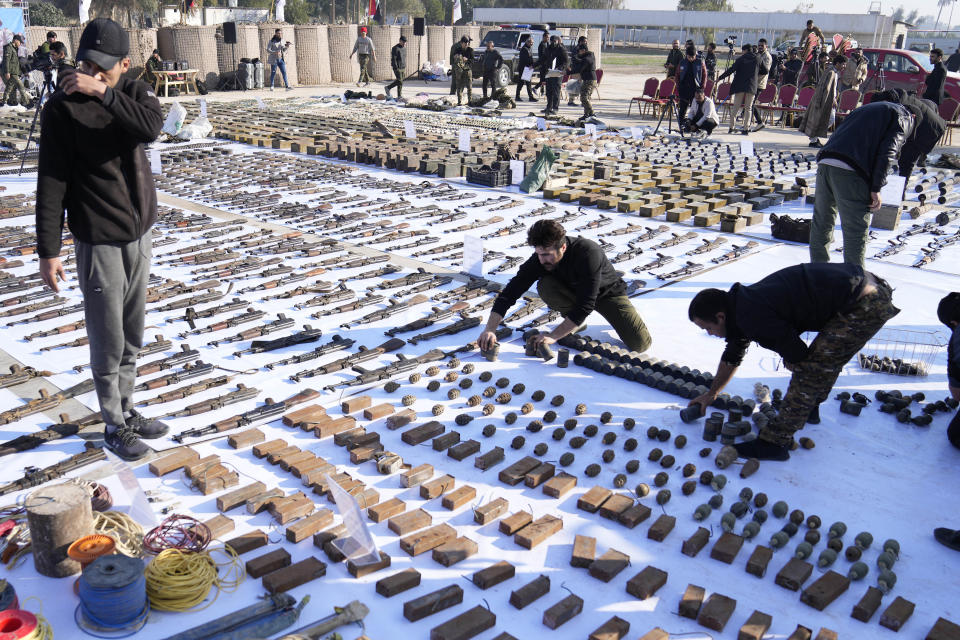 FILE - The Popular Mobilization Forces (PMF) display weapons seized from ISIS in Salahuddin province, north of Baghdad, Iraq, Thursday, Jan 12, 2023. In an interview with The Associated Press, Tuesday, Jan. 24, 2023, Pope Francis said that the arms industry has brought untold death and destruction to the world. “The world is obsessed with weapons,” he added. (AP Photo/Hadi Mizban, file)