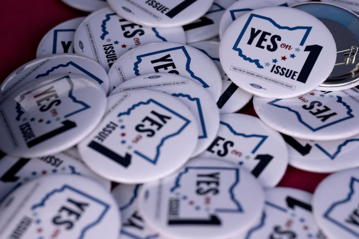 Buttons supporting a Yes vote on Issue 1 are distributed at the Planned Parenthood table during the “Bans Off Ohio Day of Action” rally at Washington Park in Cincinnati on Sunday, Oct. 8, 2023.