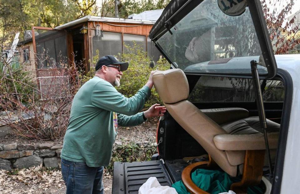 Neal Dawson pushes his living room chair into the back of his pickup truck while packing up to move out of the home he and his wife Nancy have lived in for years in the El Portal Trailer Park on Sunday, March 13, 2022.