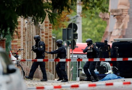 Police officers work at the site of a shooting in Halle