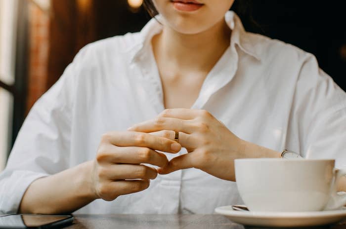 A woman playing with a wedding band