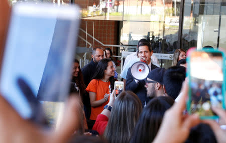 Venezuelan opposition leader Juan Guaido, who many nations have recognized as the country's rightful interim ruler, talks as he arrives to attend a meeting with students in Caracas, Venezuela February 11, 2019. REUTERS/Carlos Garcia Rawlins