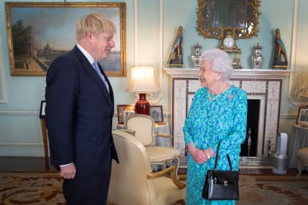 Queen Elizabeth II welcomes Boris Johnson during an audience in Buckingham Palace, where she will officially recognise him as the new Prime Minister, in London