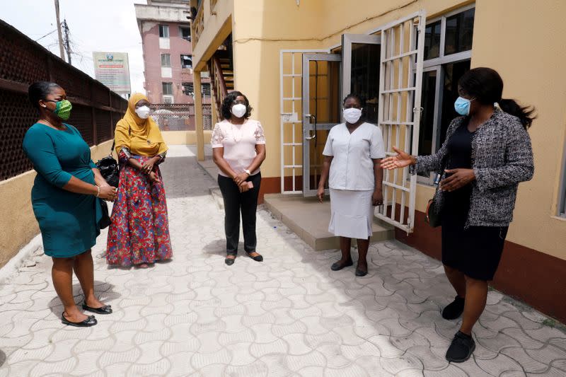 Folashade Fadare, head of the contact-tracing team, speaks with members as they prepare for the task at the Primary Healthcare Centre in Lagos