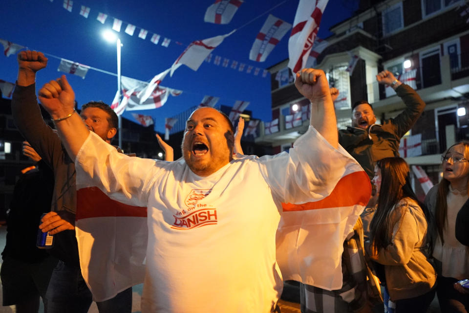 Fans celebrate the goal scored by Harry Kane at the Kirby housing estate in Bermondsey, London. 