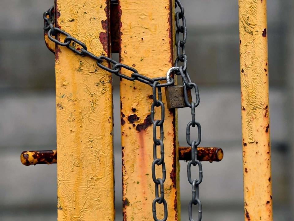 The gates at Bury's Gigg Lane were locked up on Wednesday after the club's closure: PA