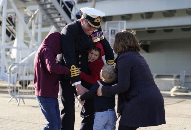 Captain Richard Hewitt, commanding officer of HMS Prince of Wales, is greeted by his wife Clara and their sons Oliver, William and Ben 