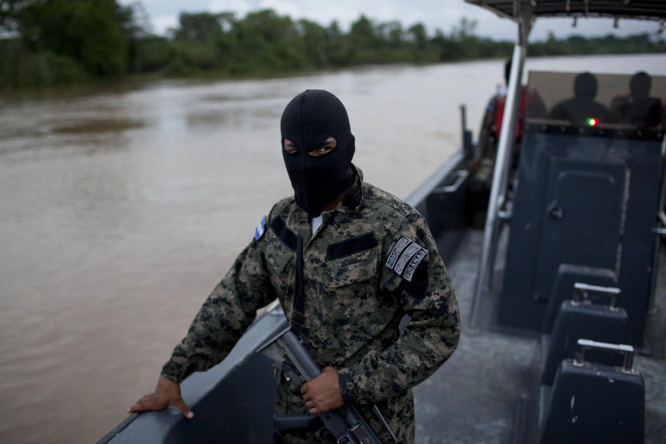 Honduran Navy officers patrol in Patuca river, near Ahuas, a remote community in La Mosquitia region, Honduras, Monday, May 21, 2012. On Friday May 11, a joint Honduran-U.S. drug raid, on a helicopter mission with advisers from the DEA, appears to have mistakenly targeted civilians in the remote jungle area, killing four riverboat passengers and injuring four others. Later, according to villagers, Honduran police narcotics forces and men speaking English spent hours searching the small town of Ahuas for a suspected drug trafficker.(AP Photo/Rodrigo Abd)