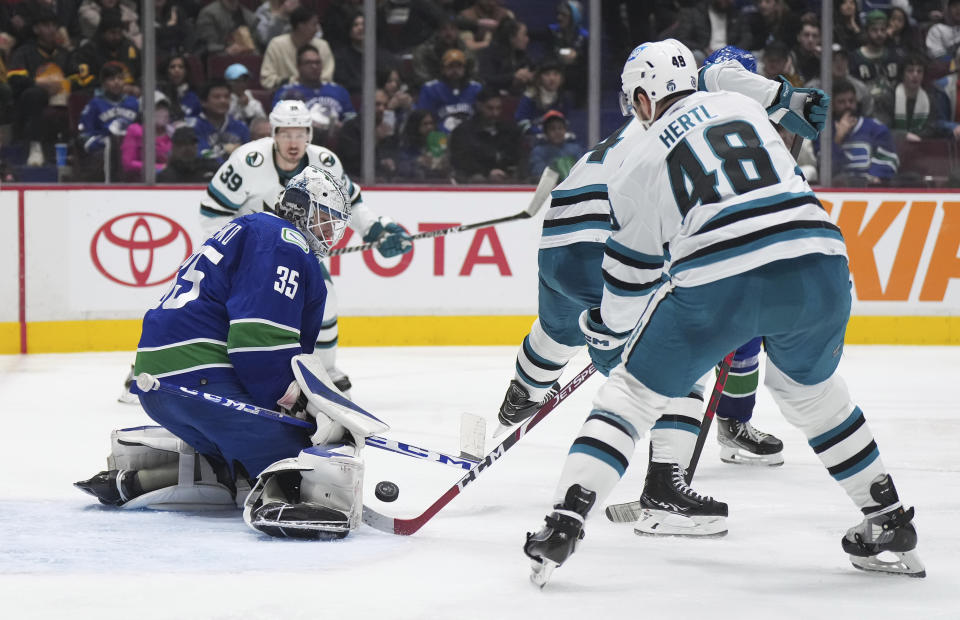 Vancouver Canucks goalie Thatcher Demko (35) stops San Jose Sharks' Tomas Hertl (48) during the second period of an NHL hockey game in Vancouver, British Columbia, Thursday, March 23, 2023. (Darryl Dyck/The Canadian Press via AP)