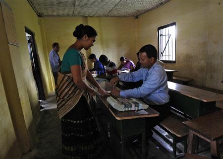 A woman gets her finger marked after voting at a polling station in Nakhrai village in Tinsukia district in the northeastern Indian state of Assam April 7, 2014. REUTERS/Rupak De Chowdhuri