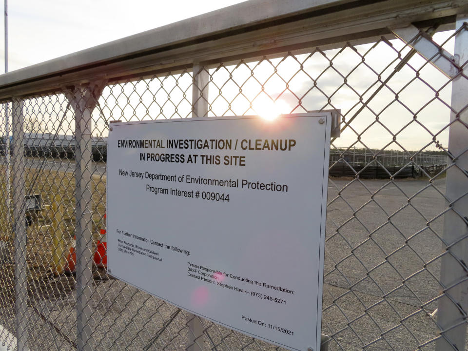 A gate at the entrance to the former Ciba Geigy chemical plant in Toms River, N.J., displays a warning sign Tuesday, Jan. 24, 2023, regarding the contaminated area, which is on the Superfund list of the nation's worst toxic waste sites. A proposed settlement to restore natural resources damaged by the company's dumping is widely opposed as insufficient by residents of Toms River, where childhood cancer rates from the late 1970s through 1990s occurred at elevated rates. (AP Photo/Wayne Parry)