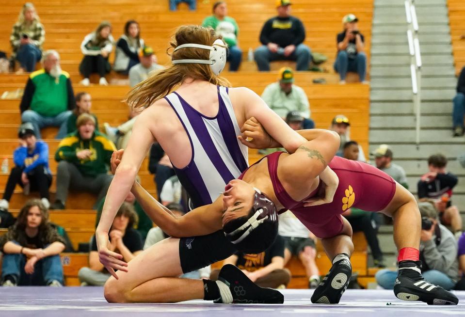 Bloomington South’s Amrin Pratt (left) wrestles against Bloomington North’s Trae Hopkins in the 132-pound third place match during the IHSAA wrestling regional at Bloomington South on Saturday, Feb. 3, 2024.