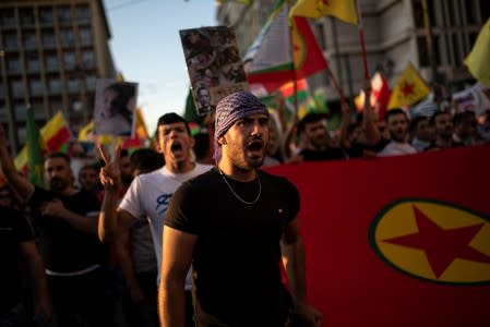 Kurds living in Greece shout slogans during a demonstration against Turkey's military action in northeastern Syria, in Athens