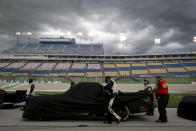 A pit crew covers a truck during a weather delay at a NASCAR Truck Series race Saturday, July 11, 2020, in Sparta, Ky. (AP Photo/Mark Humphrey)