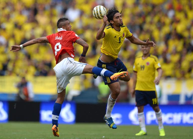 Chile's midfielder Arturo Vidal (L) and Colombia's Abel Aguilar jump for the ball during their Brazil 2014 World Cup South American qualifier match, in Barranquilla, Colombia, on October 11, 2013