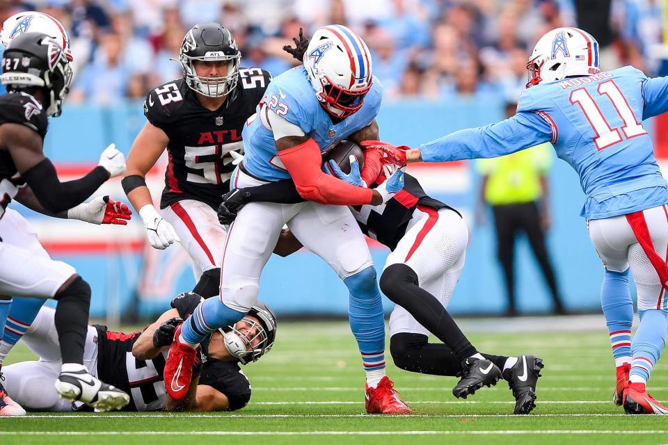 Tennessee Titans running back Derrick Henry (22) runs the ball against the Atlanta Falcons during the second half at Nissan Stadium.