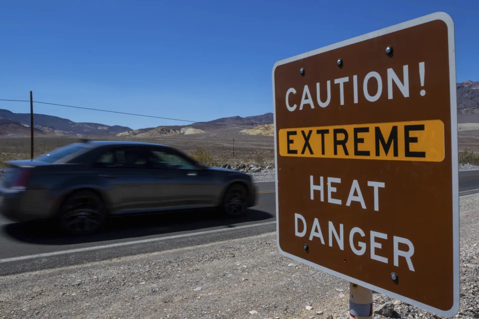 A sign stands warning of extreme heat Tuesday, July 11, 2023, in Death Valley National Park, Calif. July is the hottest month at the park with an average high of 116 degrees (46.5 Celsius). (AP Photo/Ty ONeil)