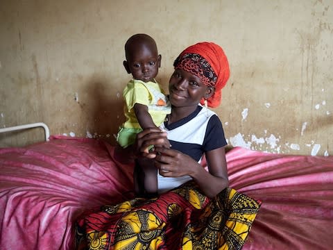 Binta Doumbouya, 19, with her 10-month-old son Bandjou - Credit: Francesco Brembati