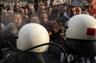 Protesters clash with police before a conference of Greek and German mayors in the northern Greek port city of Thessaloniki. Dozens of anti-austerity protesters broke into a conference and clashed with police to demonstrate against the presence of a German government official.