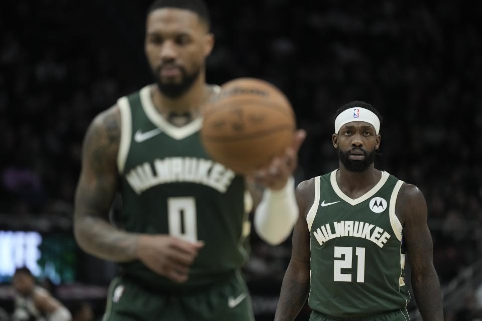 Milwaukee Bucks Patrick Beverley watches Damian Lillard shoots a free throw during the first half of an NBA basketball game against the Charlotte Hornets Friday, Feb. 9, 2024, in Milwaukee. (AP Photo/Morry Gash)