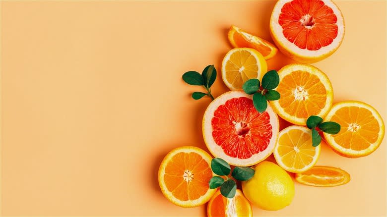 Sliced colorful citrus fruits with leaves 