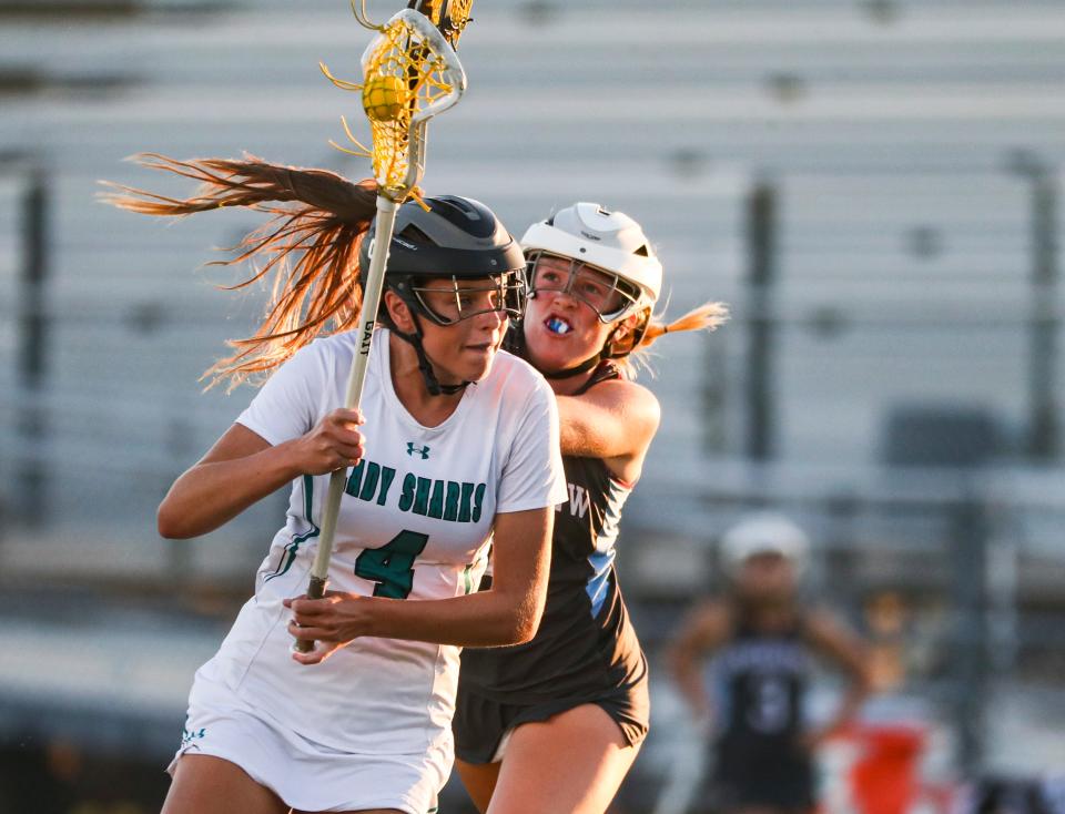 Gulf Coast Sharks attacker Kali Cleary (4) handles the ball during the first half of the Class 2A regional quarterfinal game against the Sarasota Riverview Rams at Gulf Coast High School in Naples on Tuesday, April 18, 2023.