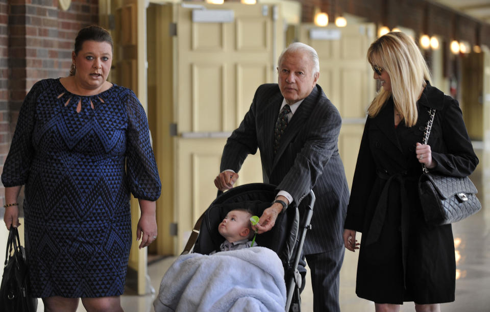 Former Louisiana Gov. Edwin Edwards, center, walks down the hallway pushing his son, Eli, as he is accompanied by wife Trina Scott Edwards, right, and Charlotte Guedry, left, before speaking at the Baton Rouge Press Club in Baton Rouge, La., Monday, March 17, 2014. Edwards announced that he would join the race to represent the state’s Baton Rouge-based 6th District of the U.S. House of Representatives. (AP Photo/Travis Spradling)