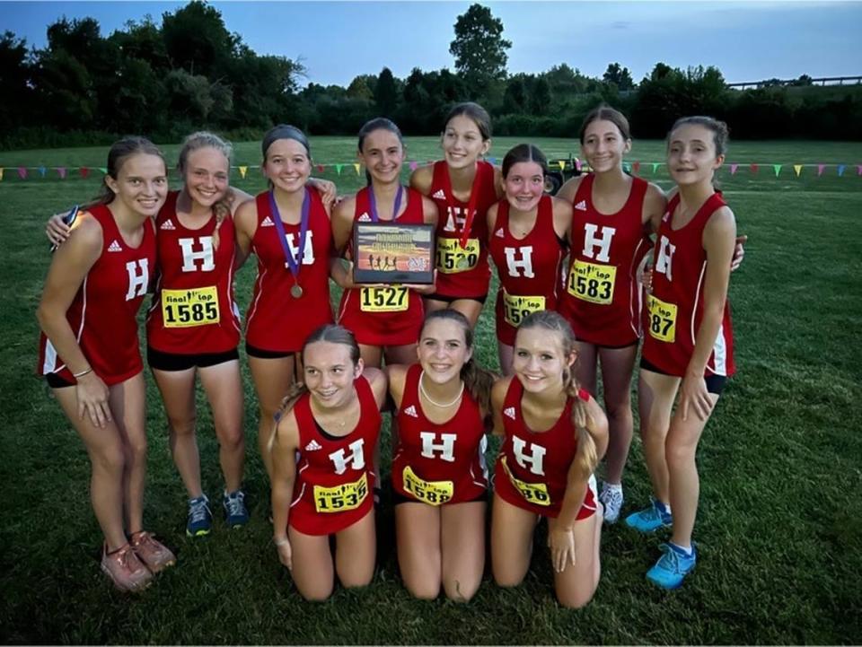 The Highland High School boys and girls cross country teams lived up to preseason expectations as they both earned first place honors at the Twilight Invitational hosted by Civic Memorial at the Bethalto Sports Complex on Saturday, Aug. 27. The girls team is pictured here with their first place trophy.